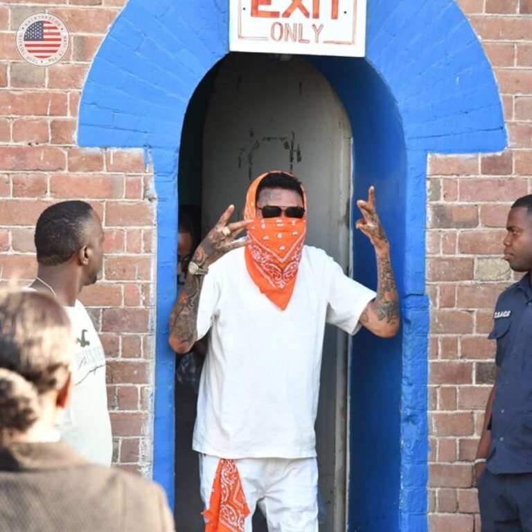 Vybz Kartel waves to supporters as he exits the courthouse following the announcement of his impending release